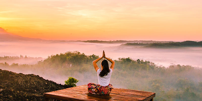 woman meditating platform mountains
